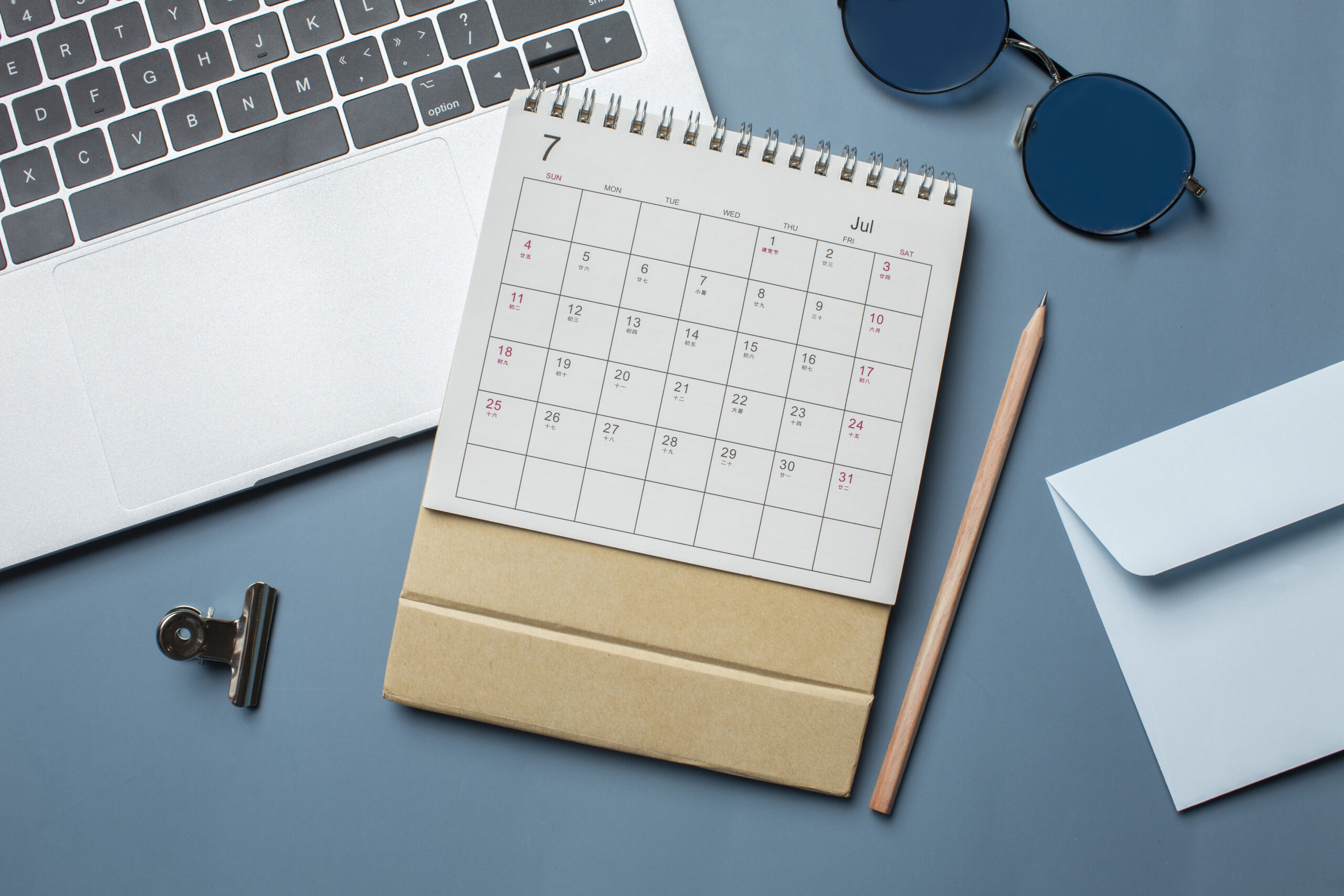 Flat lay calendar laptop arrangement scaled.jpg